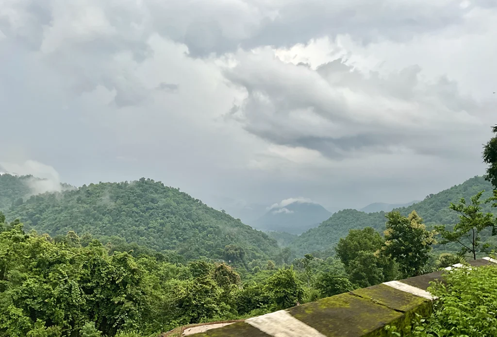 A beautiful landscape view of Araku valley with lush greenery and clouds